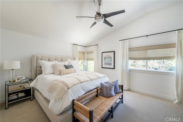 bedroom featuring light carpet, vaulted ceiling, a ceiling fan, and baseboards