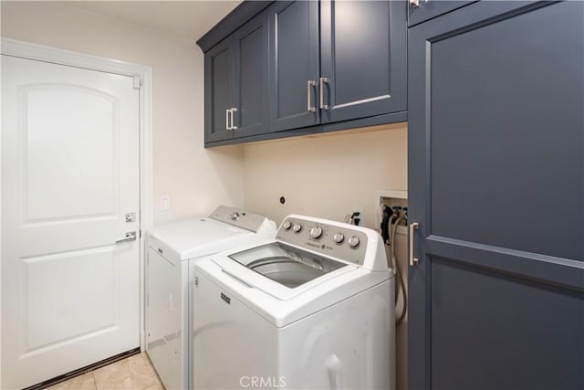 clothes washing area with cabinet space and washer and dryer