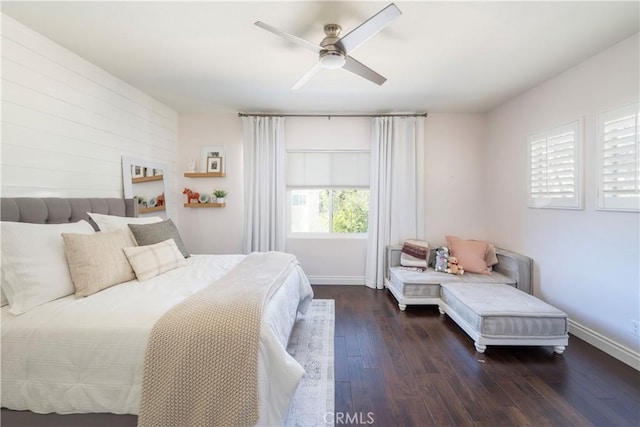 bedroom featuring ceiling fan, baseboards, and dark wood-type flooring