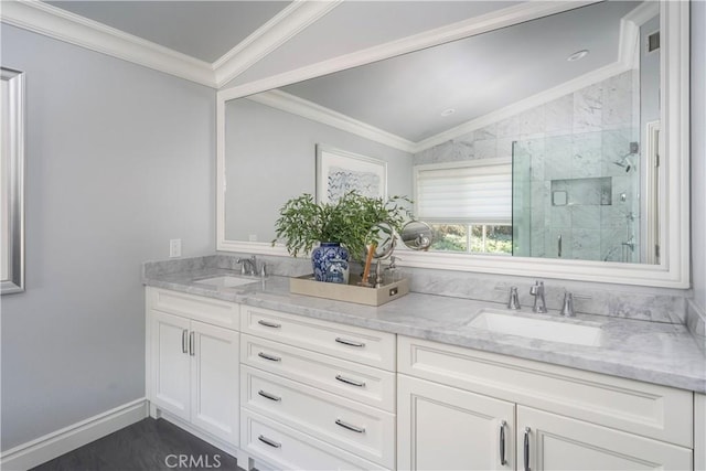 bathroom with double vanity, a marble finish shower, ornamental molding, and a sink