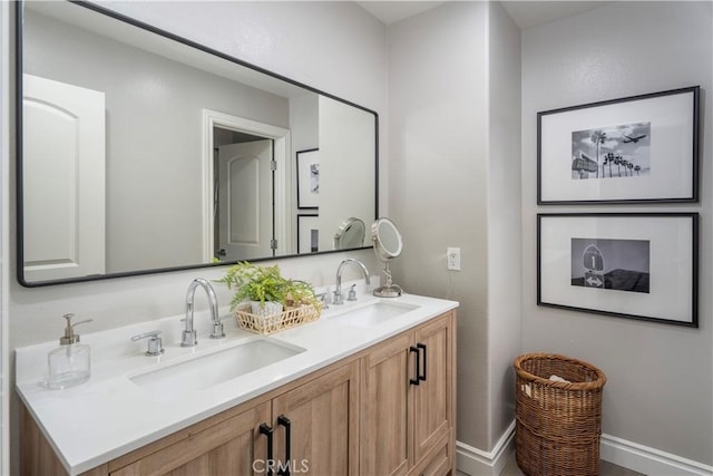 full bath with a sink and double vanity