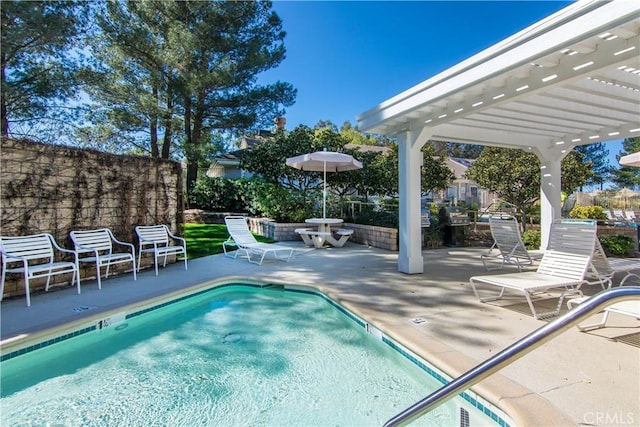 community pool with a patio area, fence, and a pergola