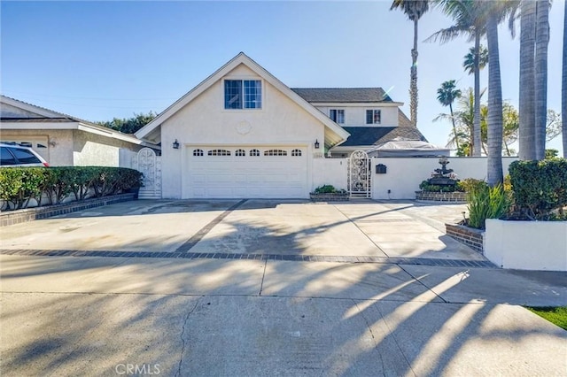 traditional-style home with concrete driveway and stucco siding