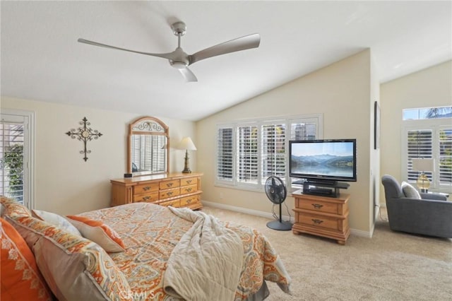 bedroom featuring multiple windows, vaulted ceiling, and light carpet