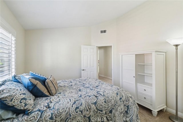 carpeted bedroom featuring visible vents and baseboards