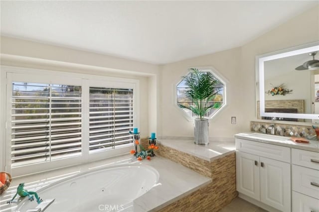 bathroom featuring a fireplace, a garden tub, and vanity