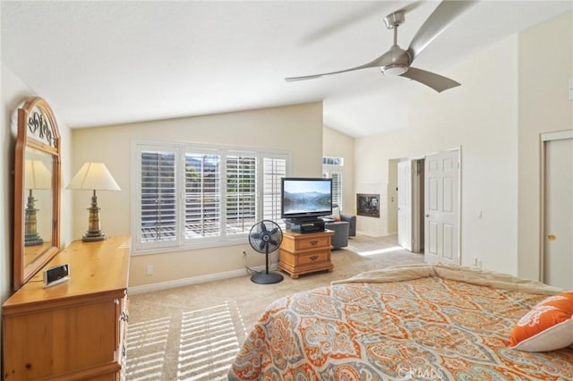 bedroom featuring light carpet, vaulted ceiling, baseboards, and ceiling fan