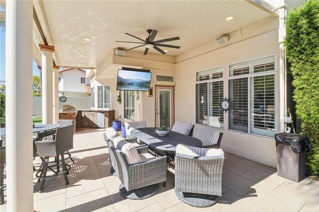 view of patio / terrace featuring exterior kitchen, outdoor dining area, and ceiling fan