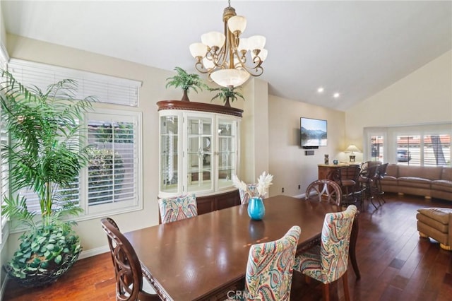 dining area with dark wood-style flooring, recessed lighting, vaulted ceiling, a chandelier, and baseboards