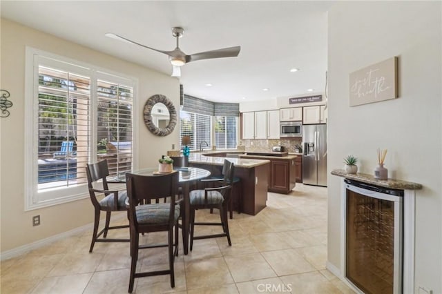 dining area featuring ceiling fan, wine cooler, light tile patterned flooring, recessed lighting, and baseboards