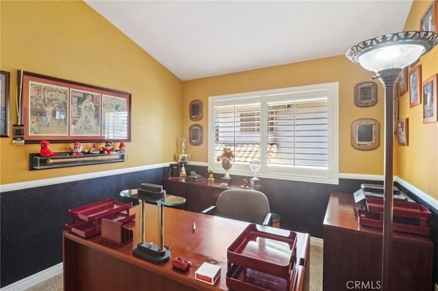 home office featuring carpet floors and vaulted ceiling