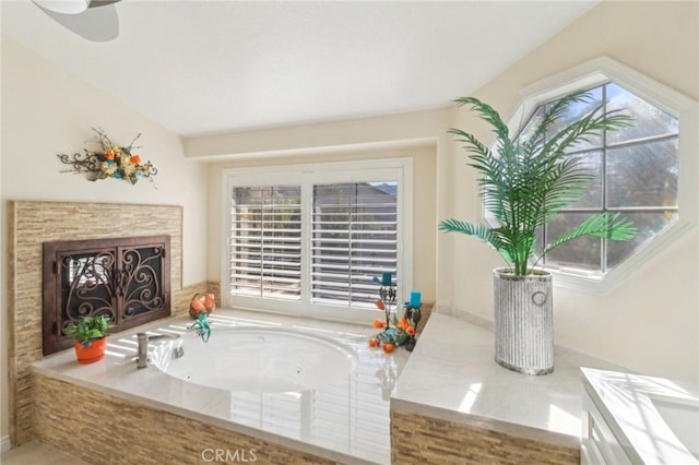 full bathroom featuring a fireplace and a bath