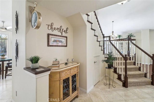 interior space with light tile patterned floors, stairs, and a notable chandelier