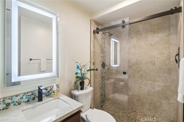 full bathroom featuring toilet, a shower stall, and vanity