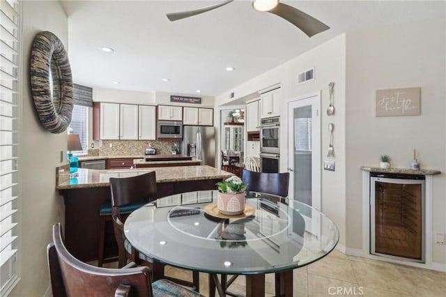 dining space with wine cooler, light tile patterned floors, recessed lighting, visible vents, and ceiling fan