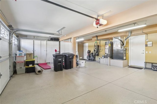 garage with strapped water heater, heating unit, and a garage door opener