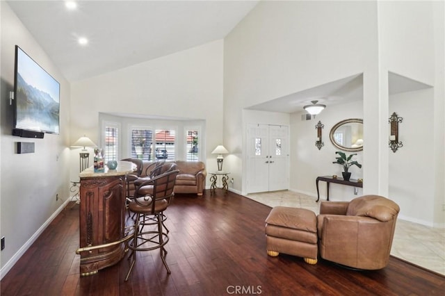 living room with wood-type flooring and baseboards