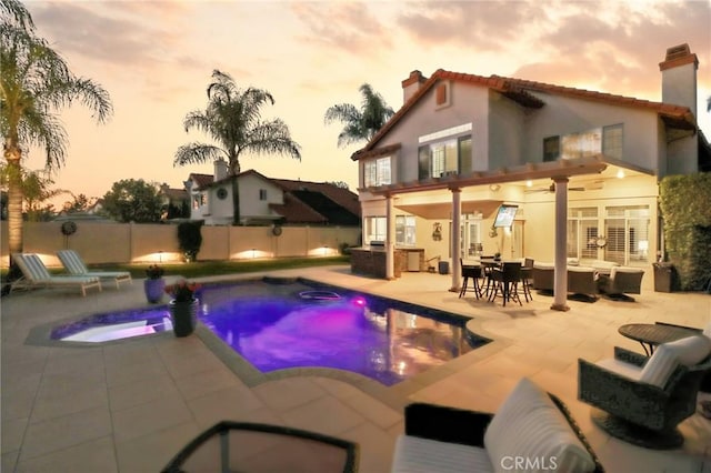 view of pool featuring an outdoor hangout area, fence, a hot tub, and a patio