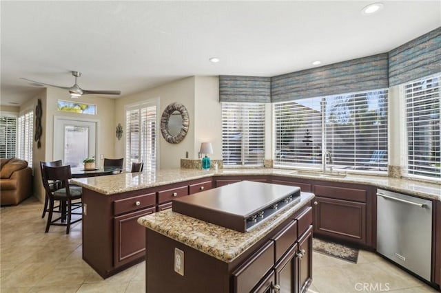 kitchen with appliances with stainless steel finishes, a center island, a sink, and recessed lighting