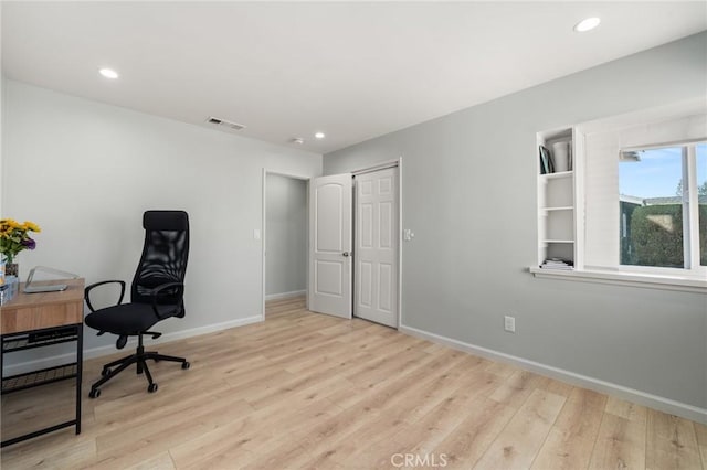 office space with light wood finished floors, visible vents, baseboards, and recessed lighting