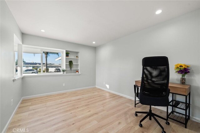 office space with light wood-type flooring, baseboards, and recessed lighting