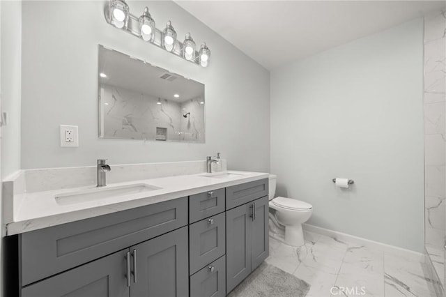 full bathroom with marble finish floor, a sink, a marble finish shower, and baseboards