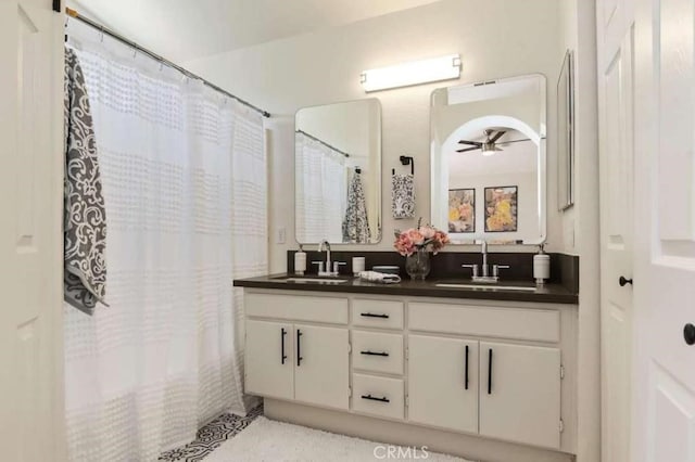 bathroom featuring a ceiling fan, a sink, and double vanity