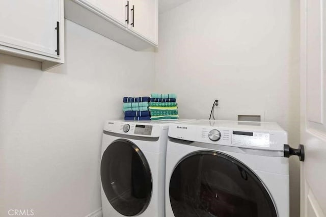 laundry room featuring cabinet space and washer and dryer