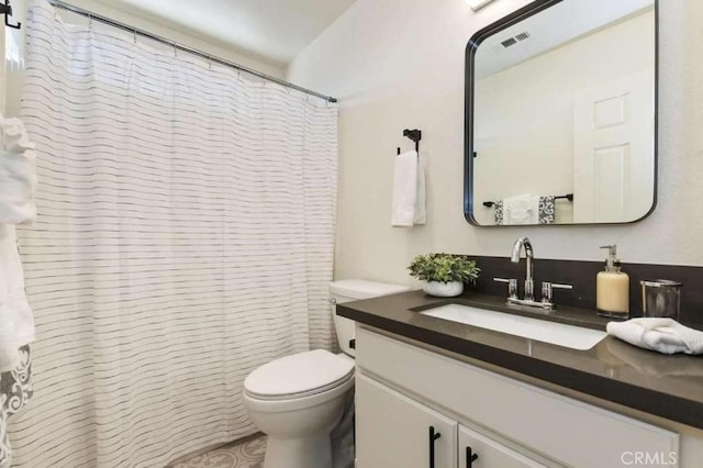 full bath with visible vents, vanity, and toilet