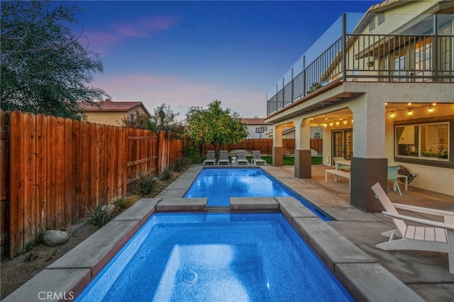 view of swimming pool featuring a fenced backyard and a pool with connected hot tub