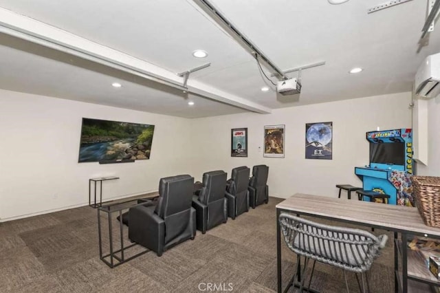 cinema room with a garage, an AC wall unit, carpet flooring, and recessed lighting