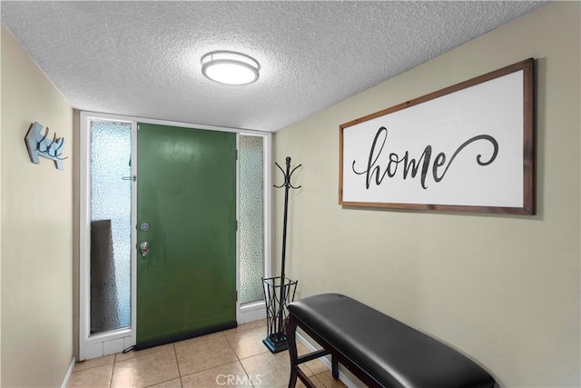 tiled entryway featuring a textured ceiling