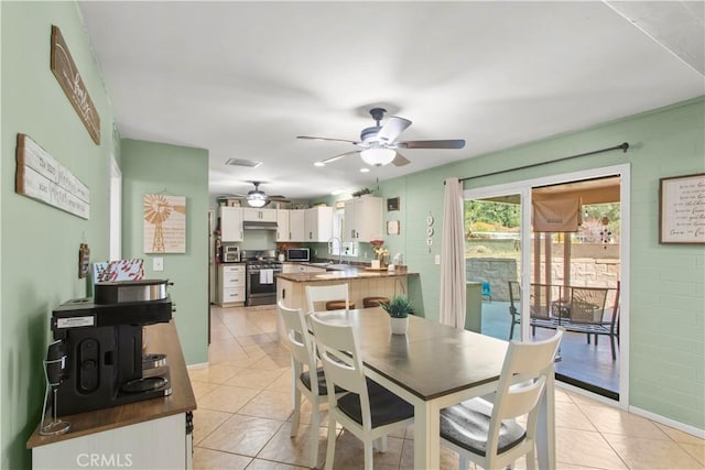 dining room with light tile patterned floors, ceiling fan, and visible vents