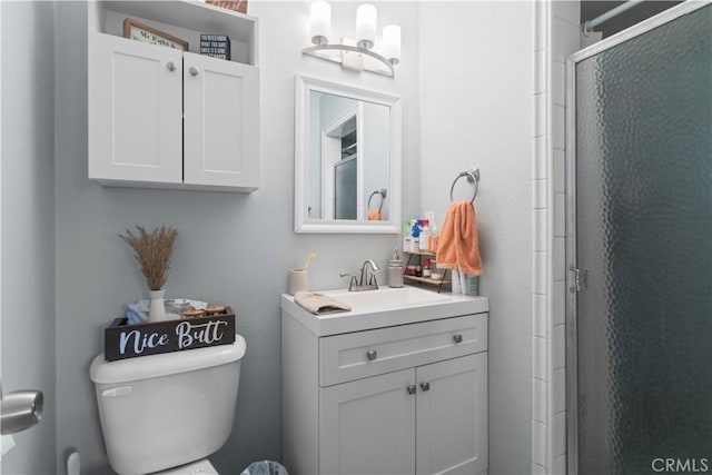 bathroom featuring toilet, a stall shower, a chandelier, and vanity