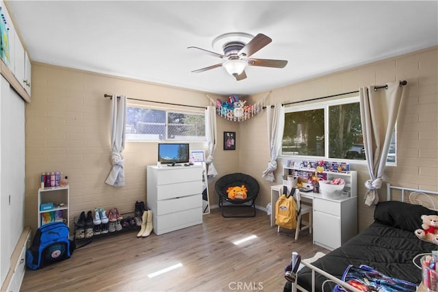 bedroom featuring a closet, ceiling fan, and light wood-style flooring