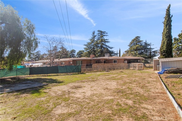 exterior space featuring an outbuilding and fence