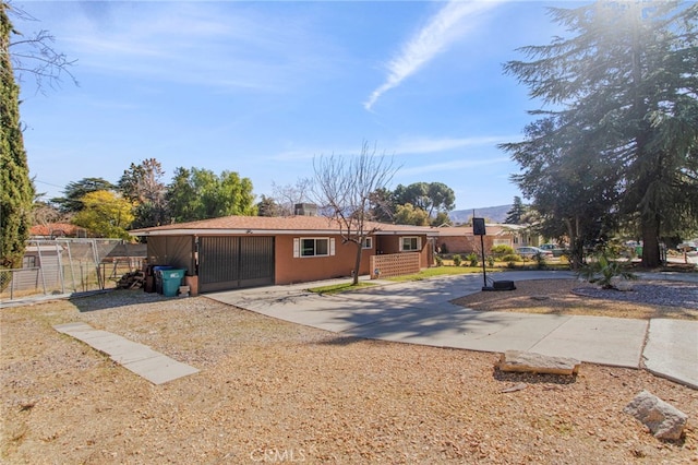 single story home with fence and concrete driveway