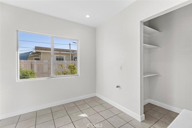 empty room with recessed lighting, baseboards, and light tile patterned floors