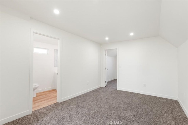 unfurnished bedroom with carpet floors, ensuite bath, baseboards, and recessed lighting