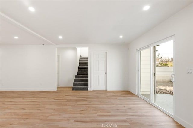 interior space featuring stairs, baseboards, light wood-style flooring, and recessed lighting