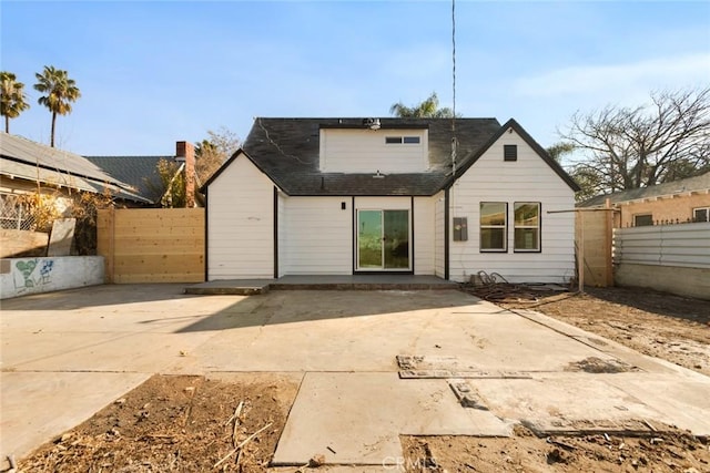 rear view of house featuring a patio area and fence