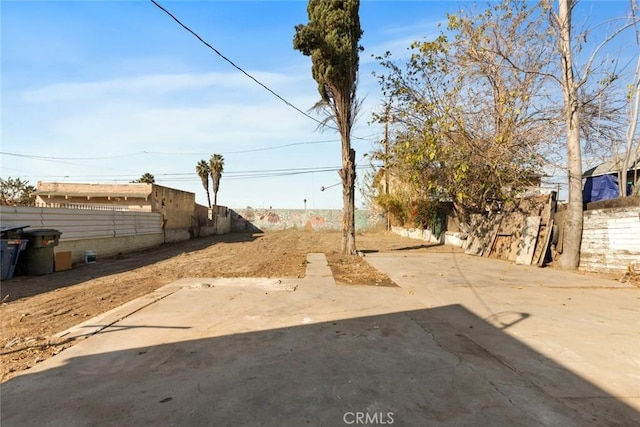 view of yard featuring fence and a patio