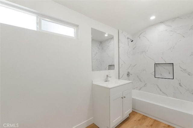 full bathroom with recessed lighting, shower / washtub combination, wood finished floors, and vanity