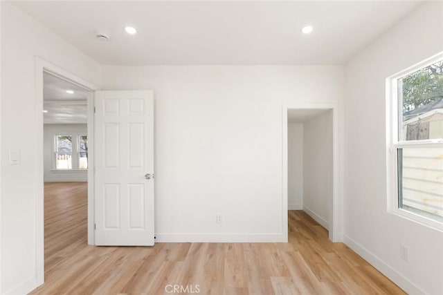 unfurnished room with recessed lighting, baseboards, and light wood finished floors