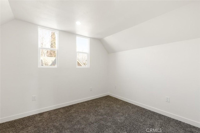 additional living space with vaulted ceiling, carpet flooring, and baseboards