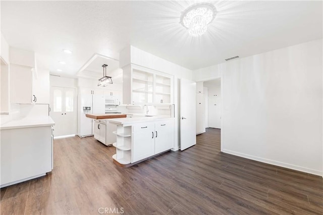 kitchen with decorative light fixtures, open shelves, visible vents, white microwave, and white cabinets