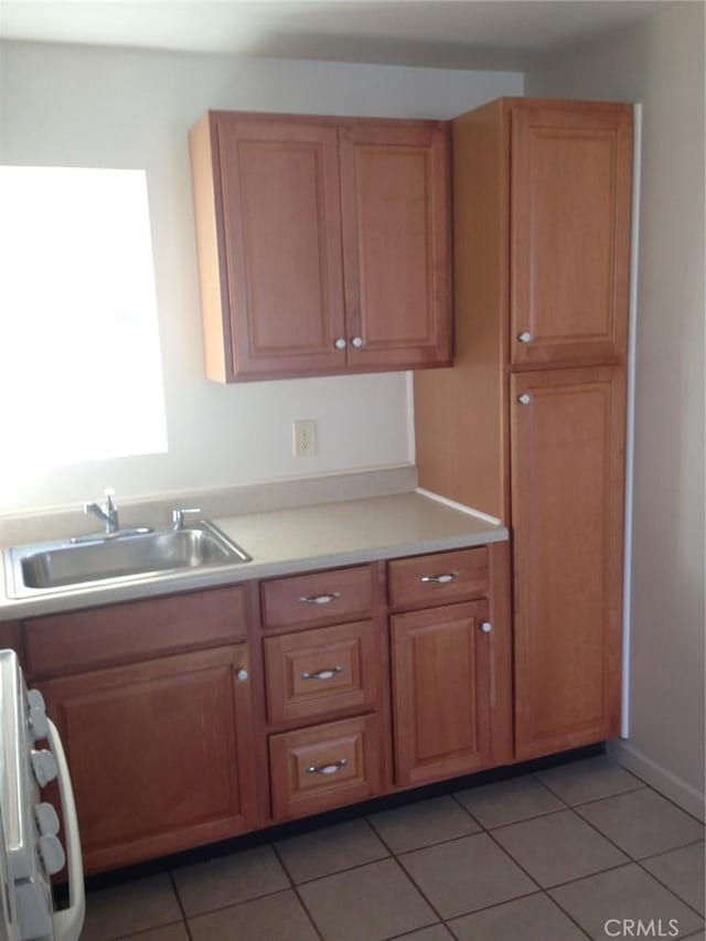 551 Hathway Ave, San Luis Obispo, CA 93405 - kitchen with light tile patterned floors, a sink, stove, and light countertops