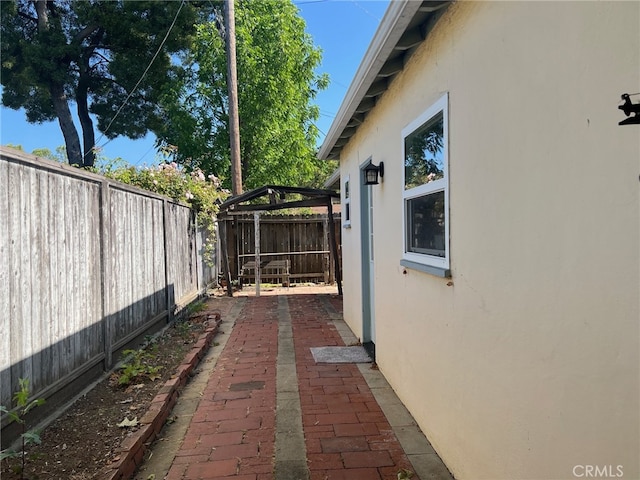 551 Hathway Ave, San Luis Obispo, CA 93405 - view of side of property with stucco siding, a fenced backyard, and a patio area