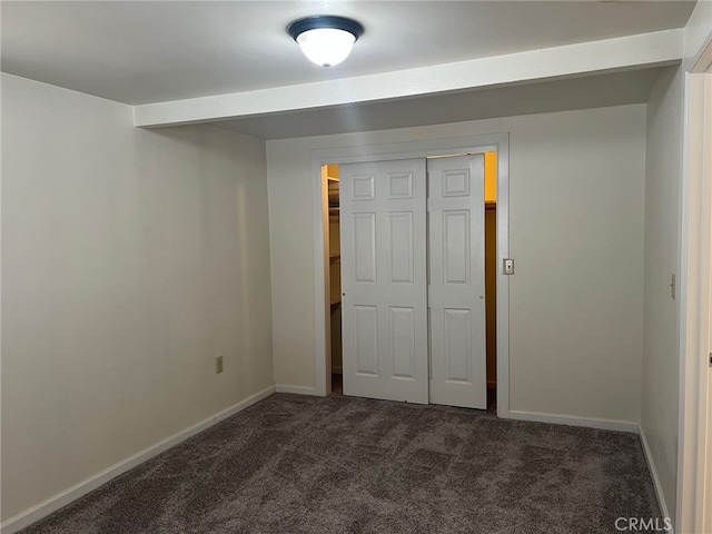 551 Hathway Ave, San Luis Obispo, CA 93405 - unfurnished bedroom featuring a closet, dark carpet, and baseboards