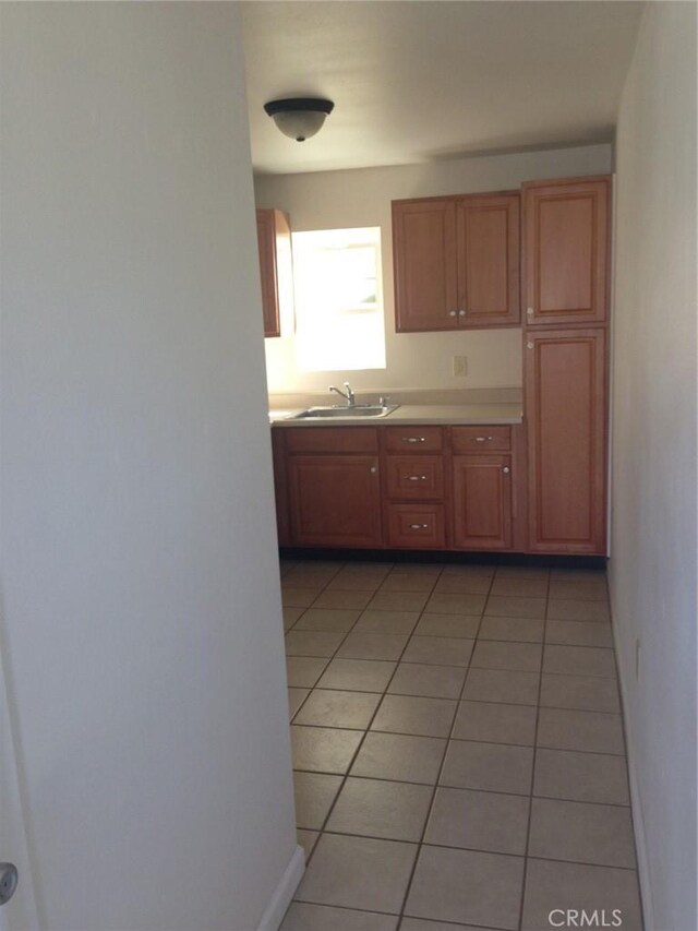551 Hathway Ave, San Luis Obispo, CA 93405 - kitchen with baseboards, light tile patterned flooring, light countertops, and a sink